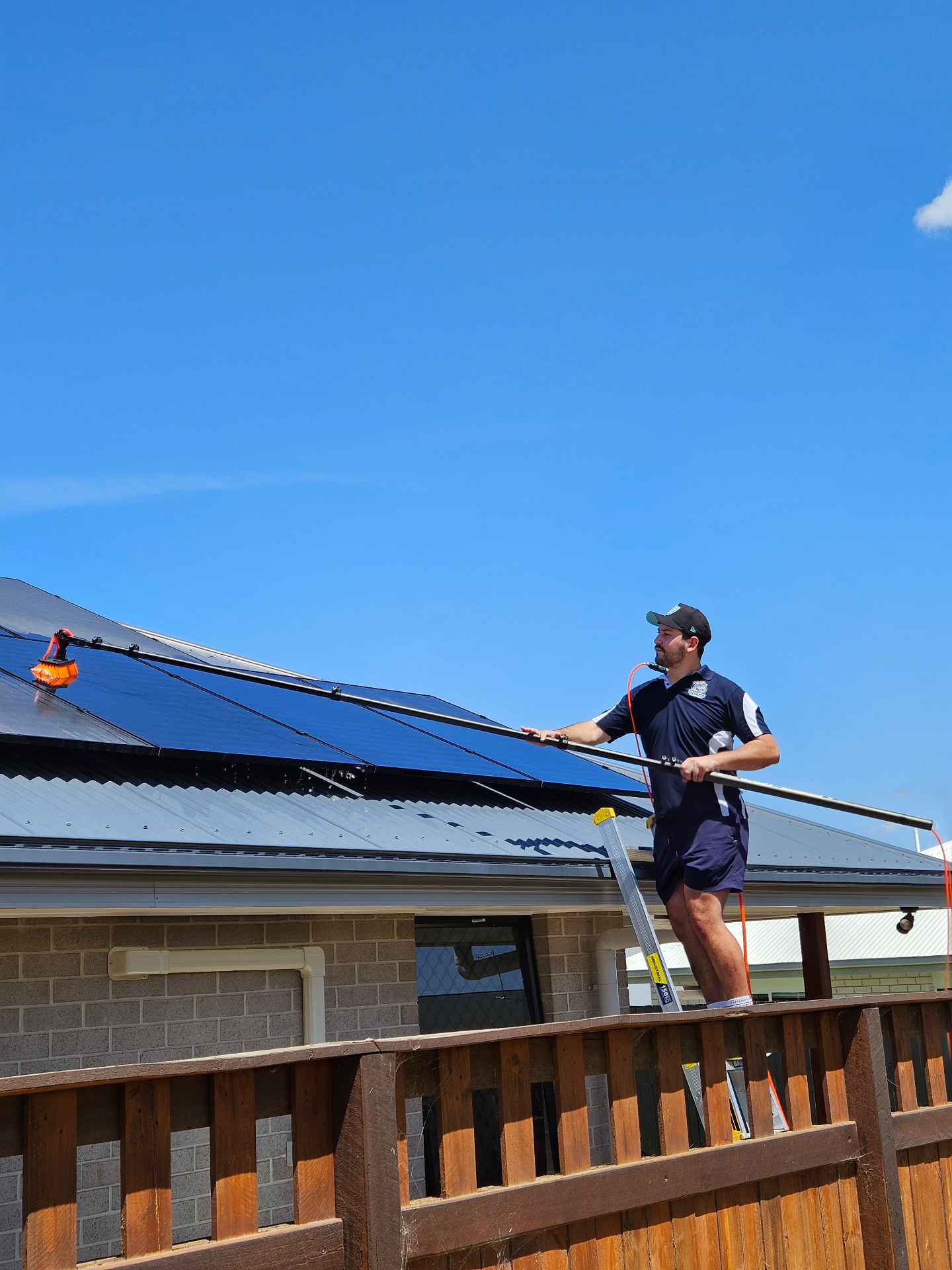 MifCo Cleaning technician cleaning residential solar panels in Brisbane